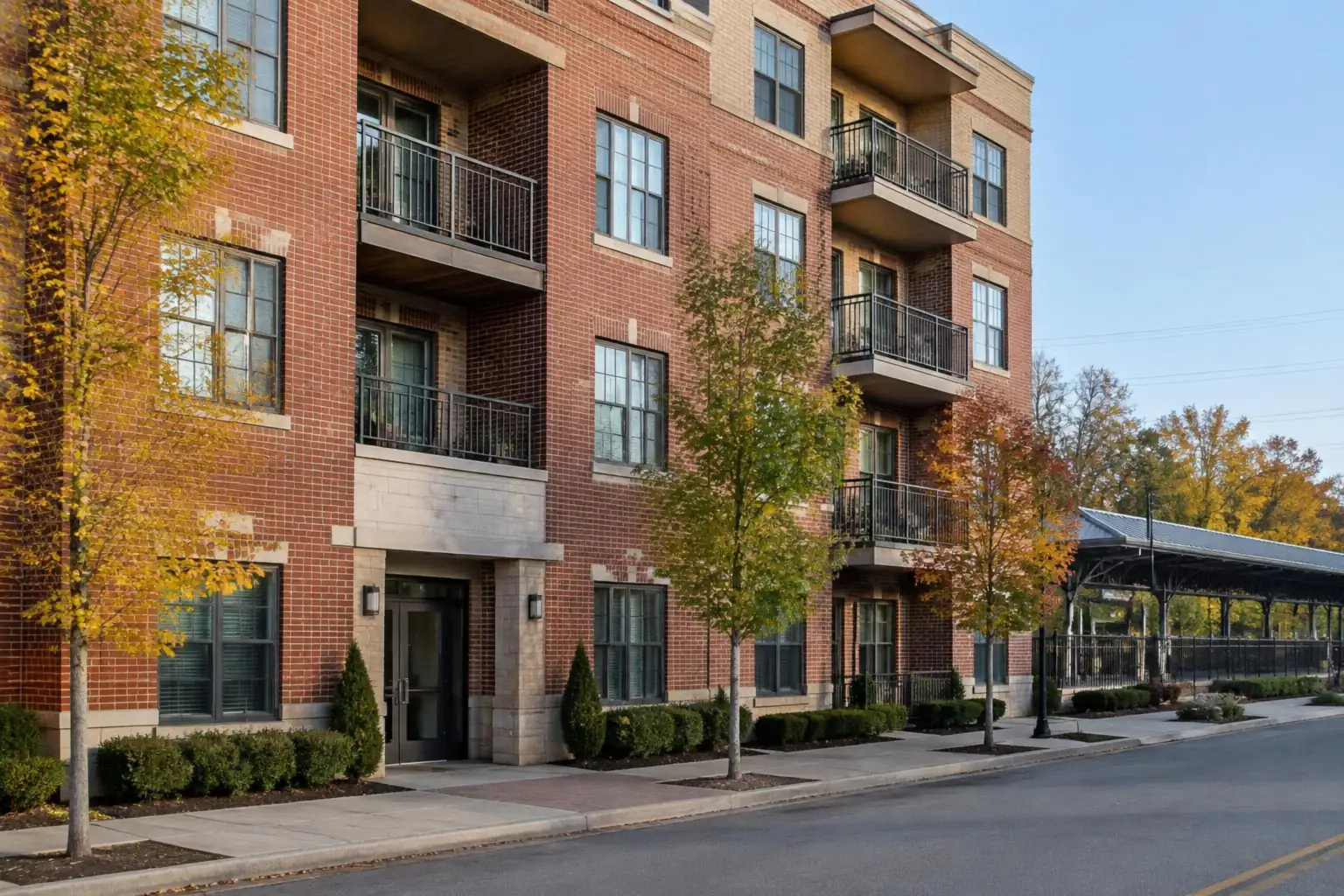Downtown Palatine condos: four-story brick building with balconies on a quiet street near the train