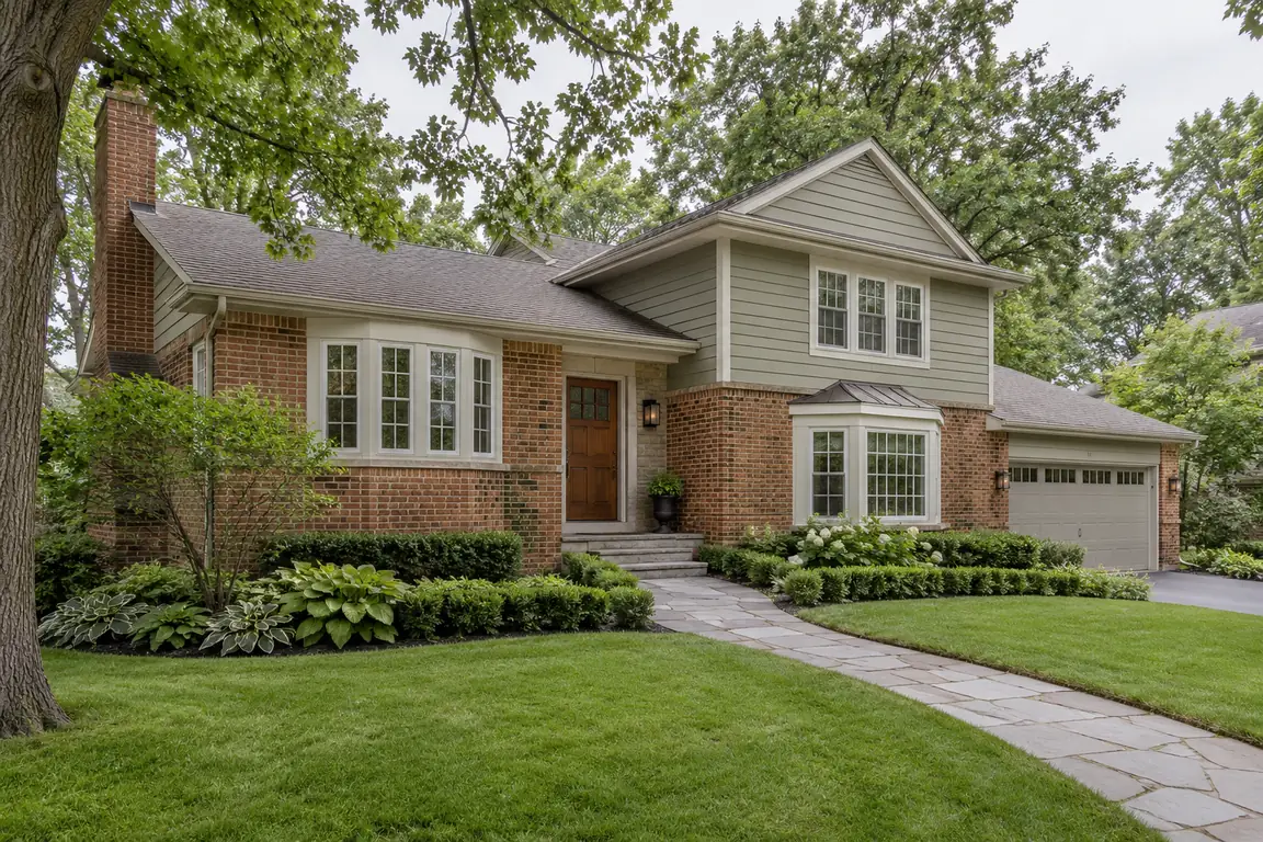 Brick and siding home with a bay window and a front walk in Palatine, IL