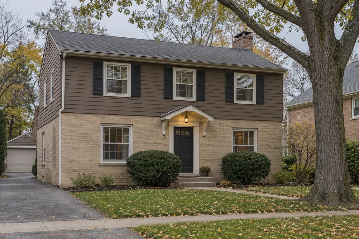 Hunting Ridge Palatine, IL home: two-story colonial with tan brick, brown siding and black shutters in fall